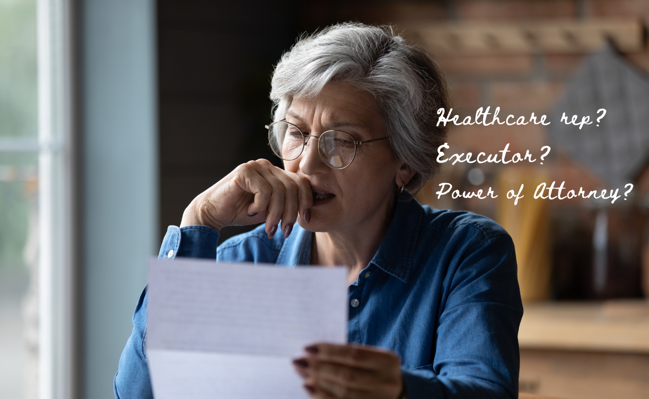 Alt text: Older woman with gray hair and glasses sitting indoors, thoughtfully reading a document. Text on the image reads: “Healthcare rep? Executor? Power of Attorney?” suggesting concerns about estate planning and decision-making roles.