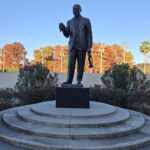 A statue of Louis Armstrong in the park.