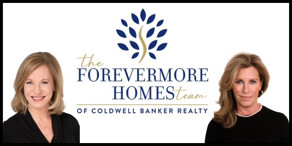 Two smiling women in black outfits with a logo for Forever Homes Coldwell Bank Realty group in the center.