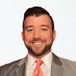 Smiling young man in a suit and tie.