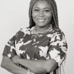 Photo of an attractive african american woman with long braids smiling.
